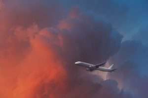 An airplane flying into a large cloud