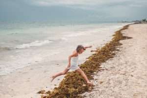 A little girl playing on Cancun's beach