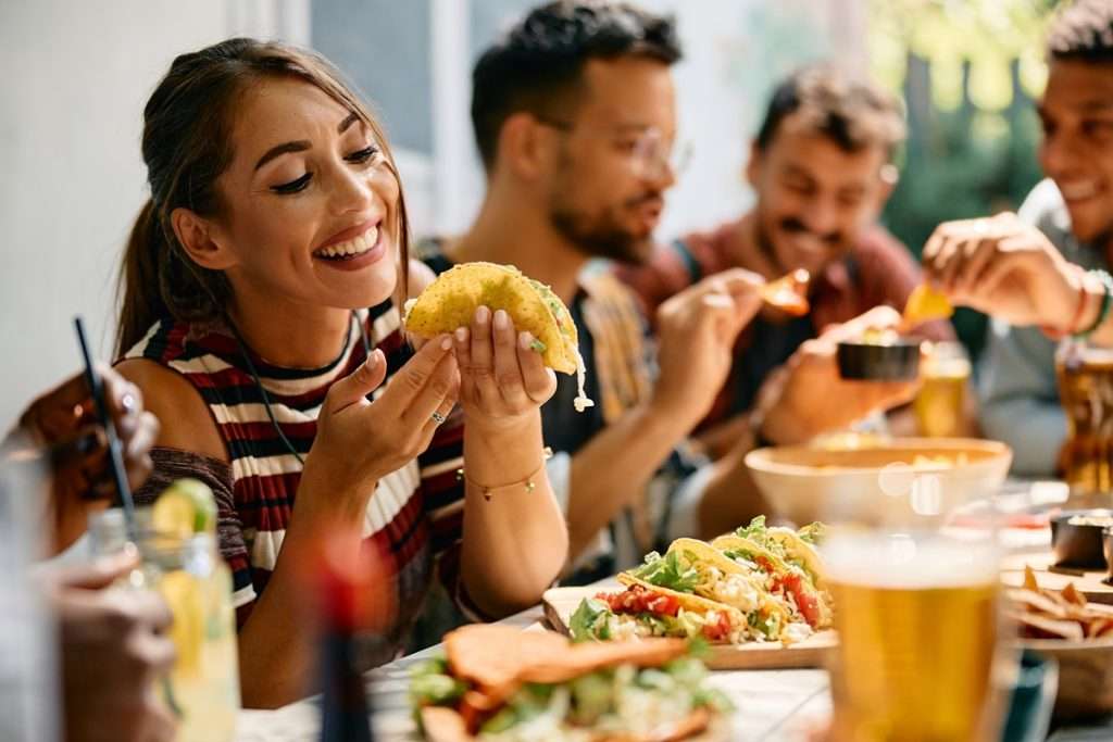 A young woman smiling and dining at a resturant
