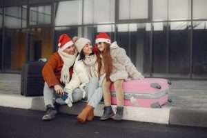 A family siting outside with their luggage