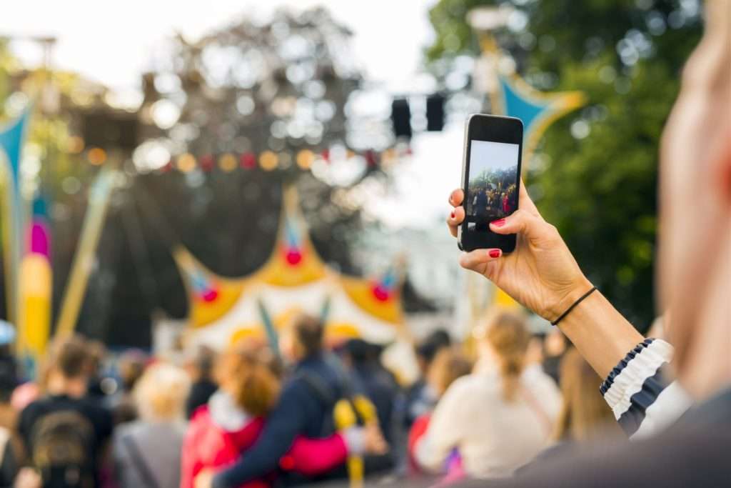 A woman taking a picture at a festival